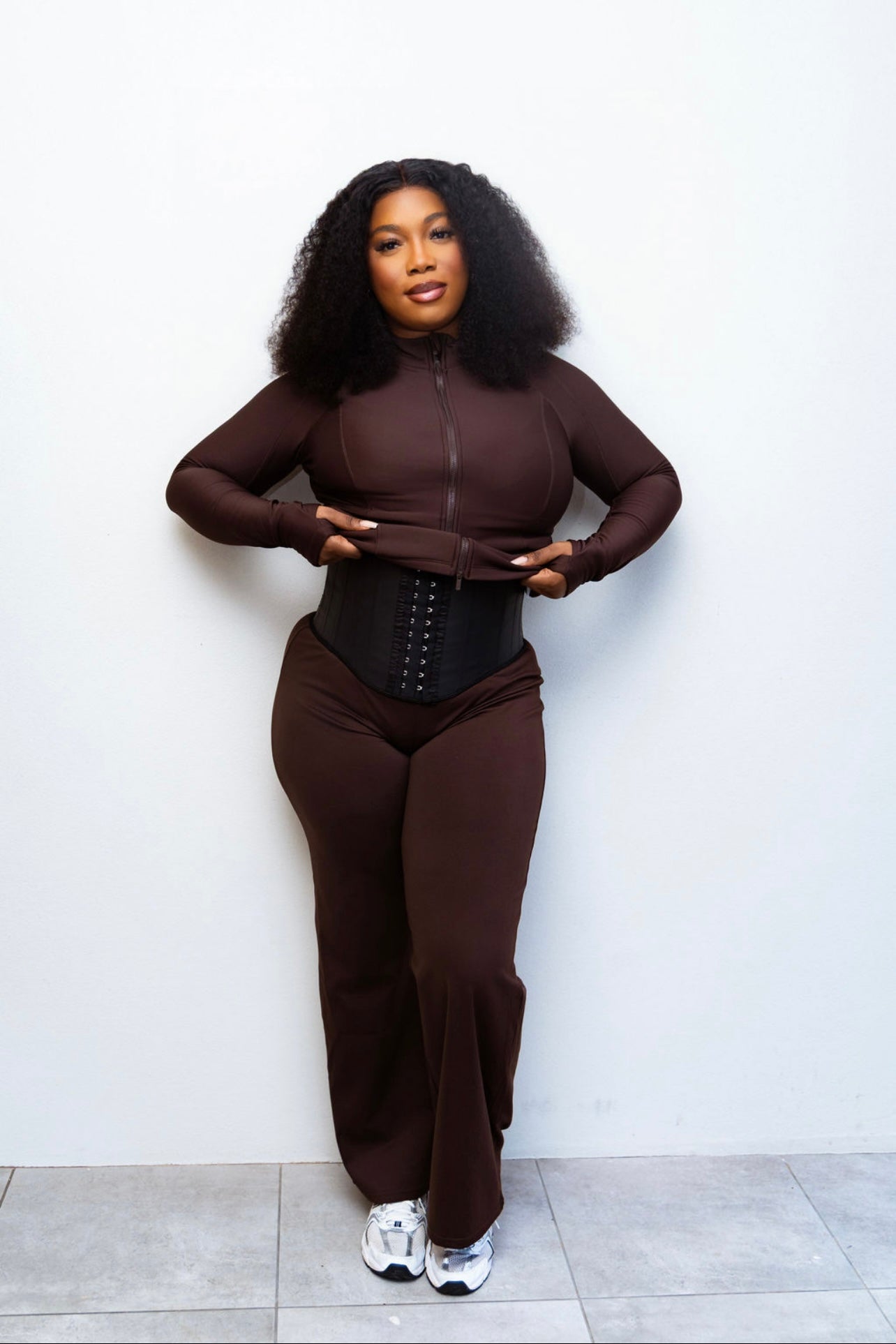 Steel bone waist trainer worn with brown sauna suit - front view