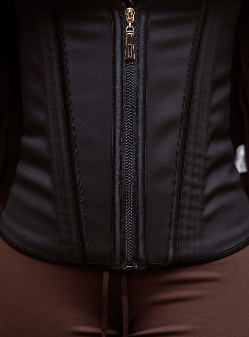 Detailed close-up of Steel Bone Waist Trainer zipper and boning panels in black