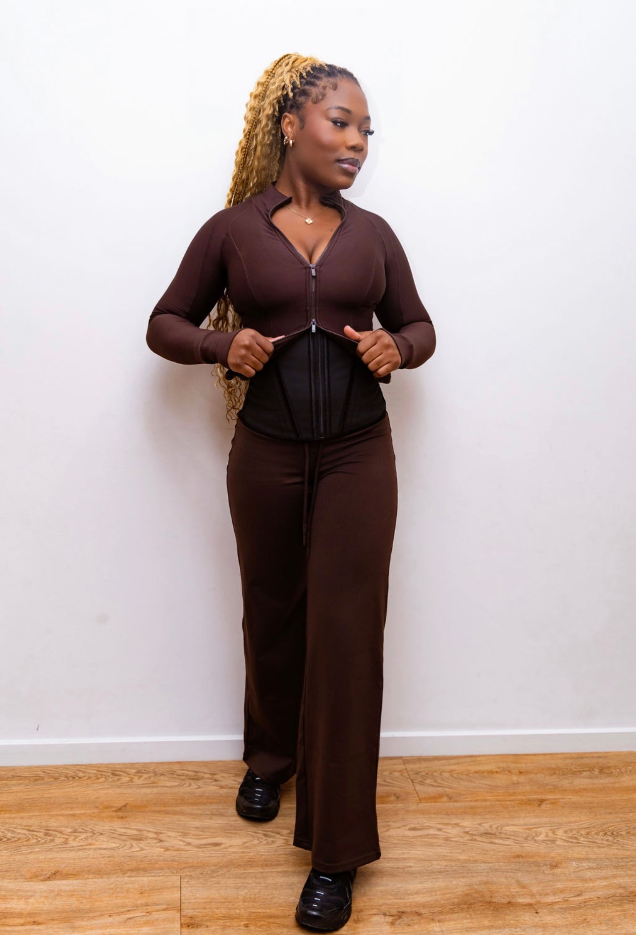 Model wearing Steel Bone Waist Trainer with brown co-ord — three-quarter side view